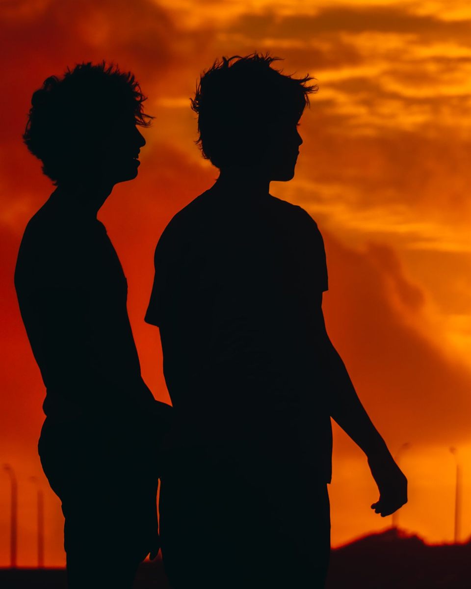Two friends together at sunset
