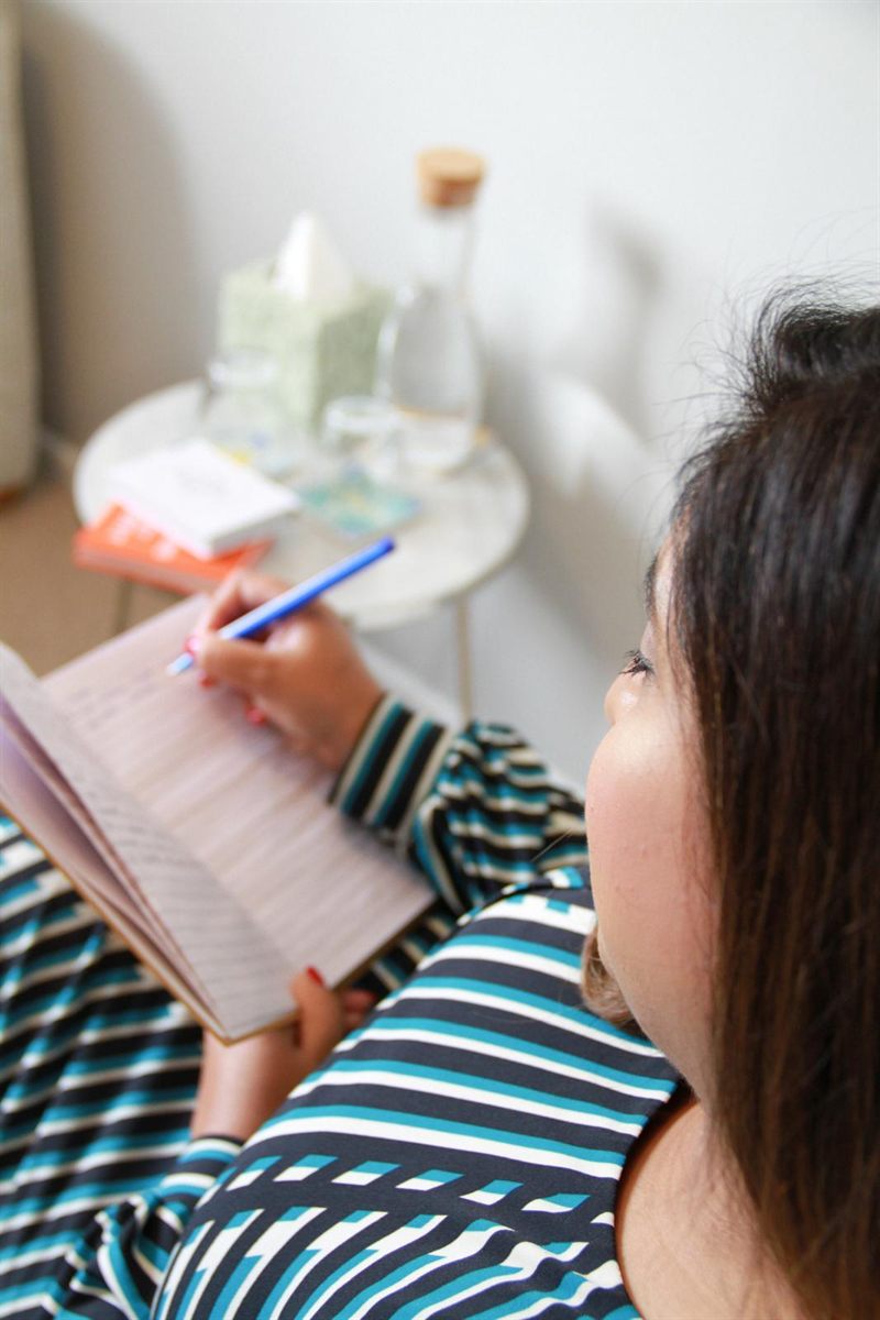 Huma making notes during a therapy session